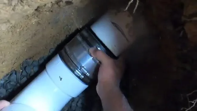 View of tightening rubber coupling on sewer line on a Boynton Beach emergency plumbing job